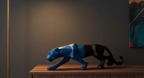 Sleek black panther showpiece with blue accents on dark walnut console table in modern living room